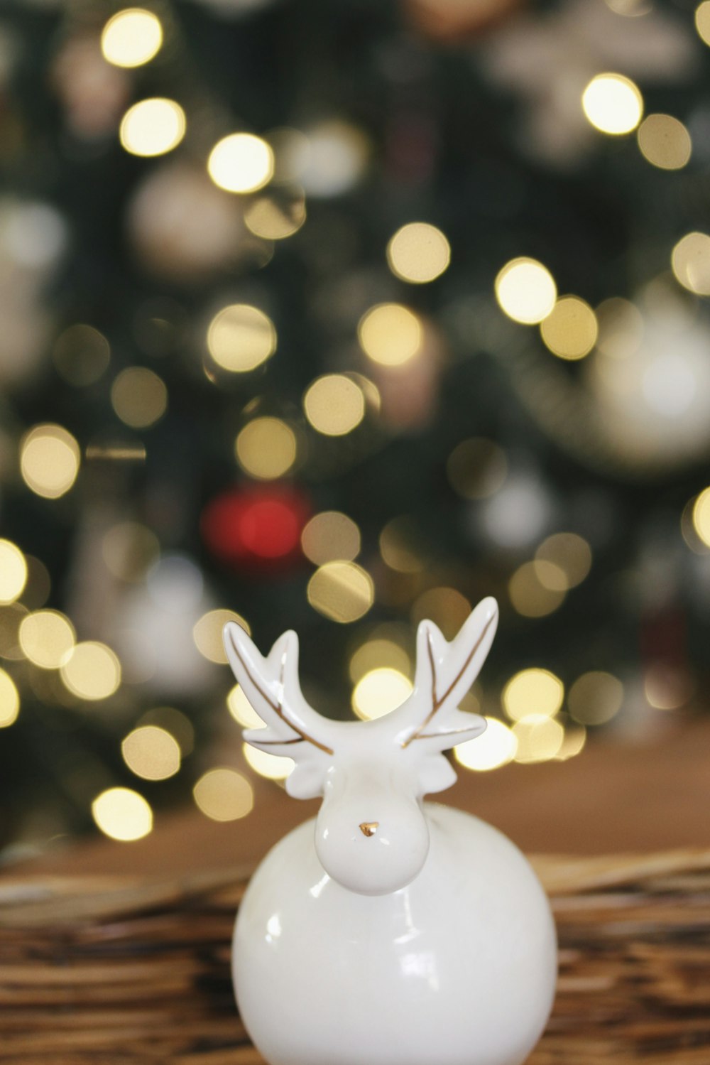 selective focus photo of white buck figurine