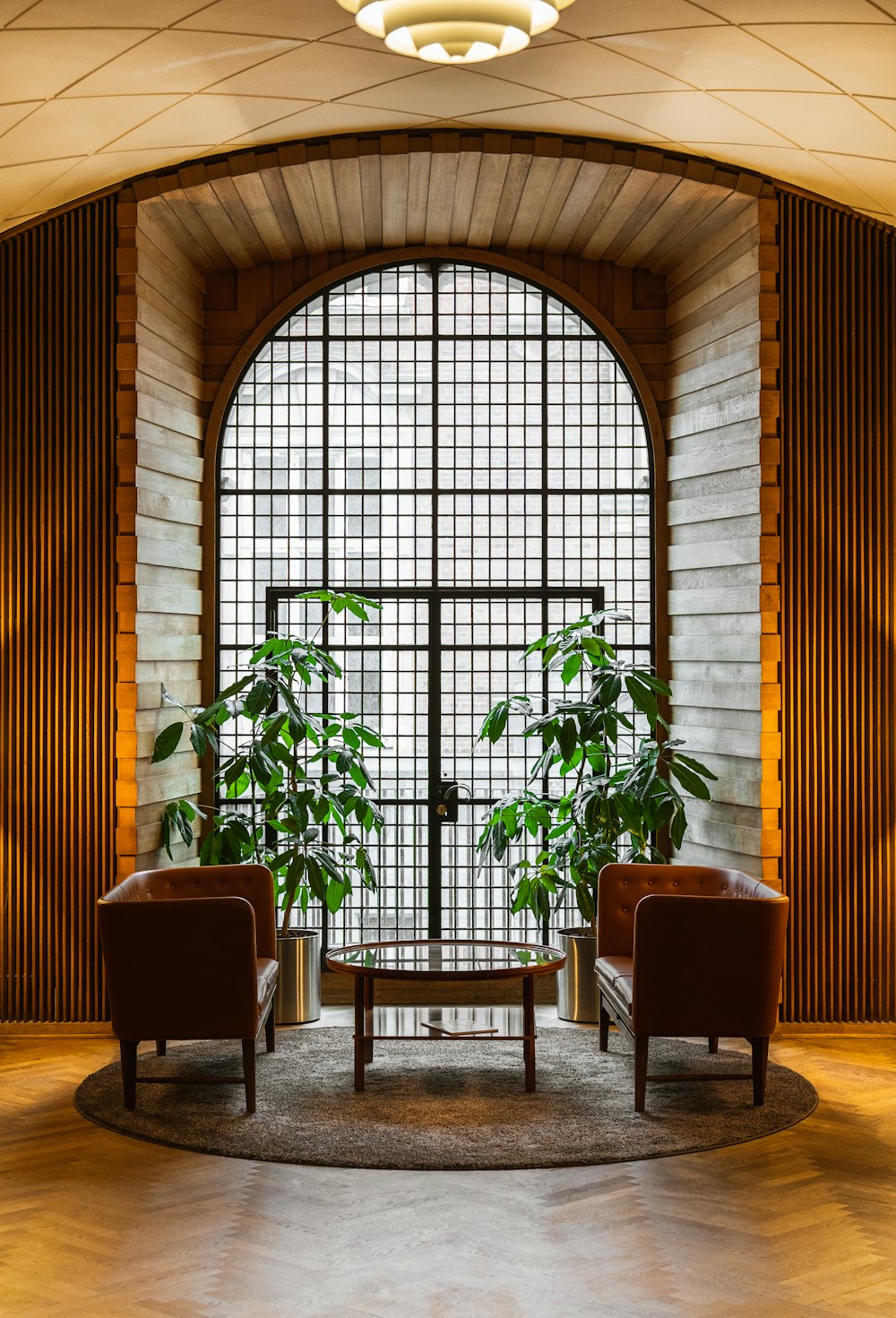 two chairs and a table in front of a large window