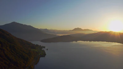 Scenic view of Saint Moritz’s lake and mountains at sunrise.