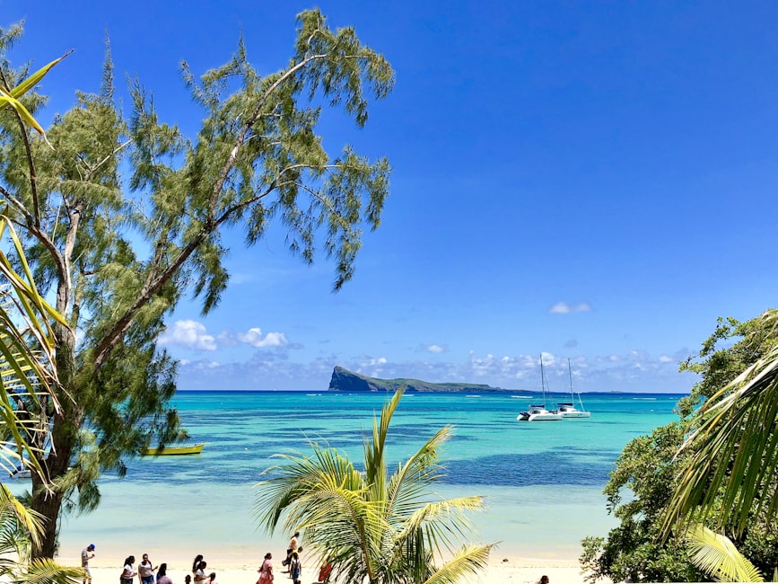 Mauritius beach 5-star resort with travelers on white sand.