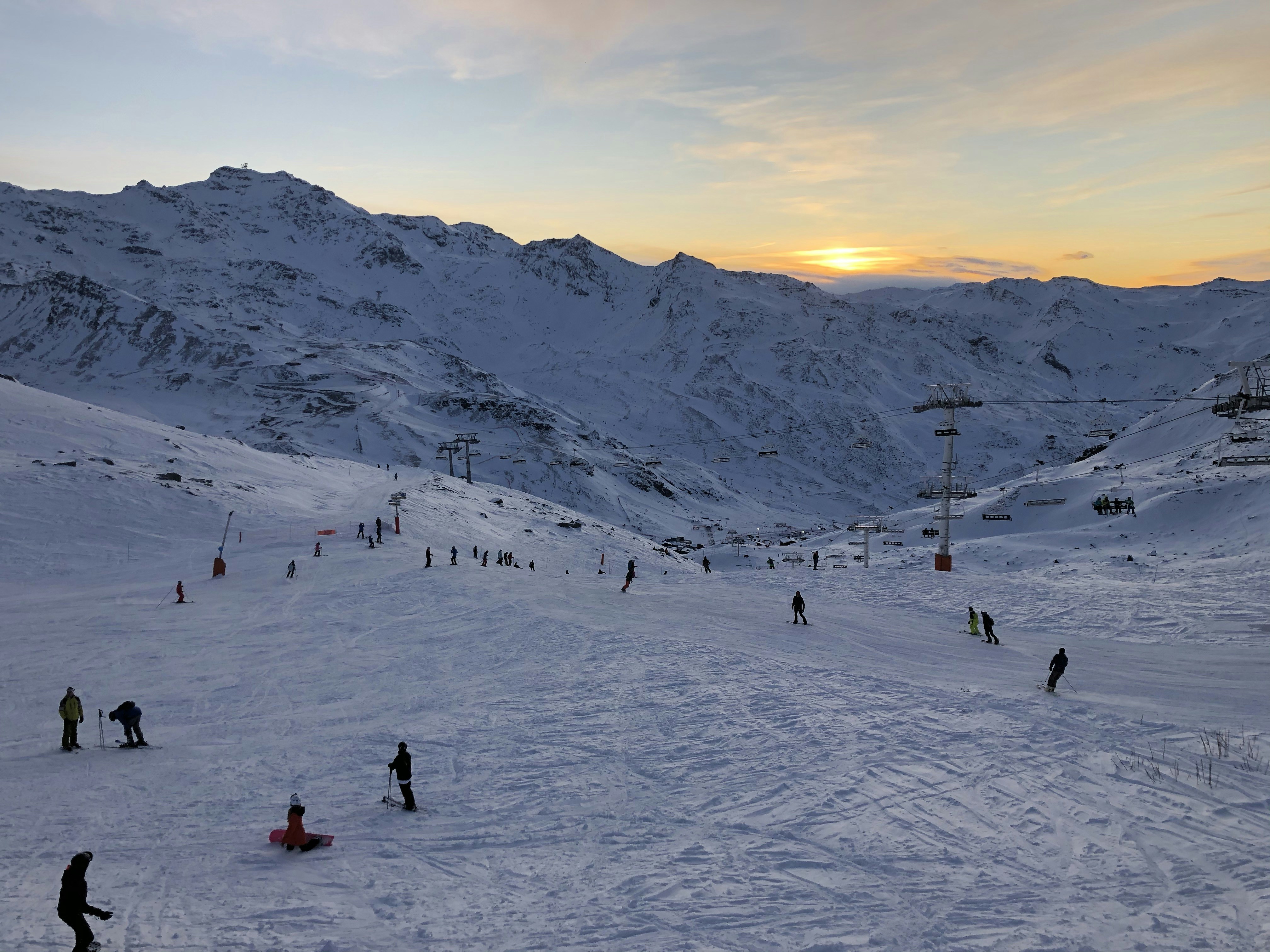 people on snow field during daytime, snowscape sunset