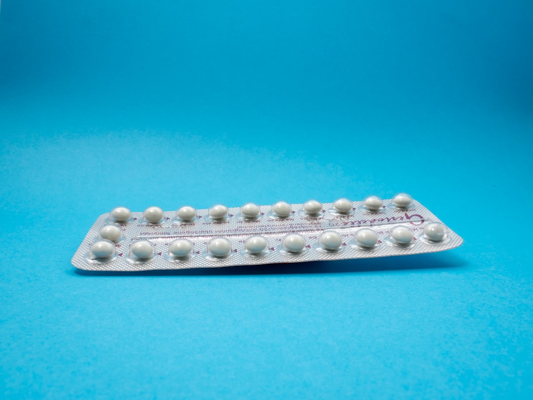 oral contraceptive pill on blue panel
