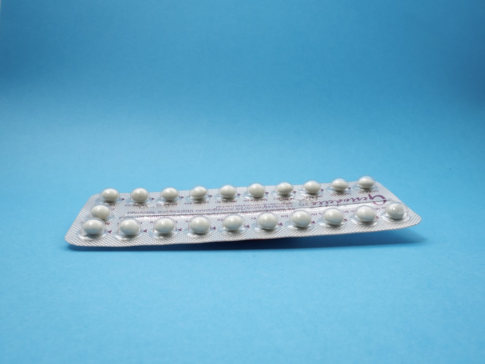 oral contraceptive pill on blue panel