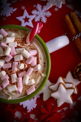 A cozy holiday scene featuring a family wearing Christmas-themed shirts and sipping from festive mugs by a decorated tree.