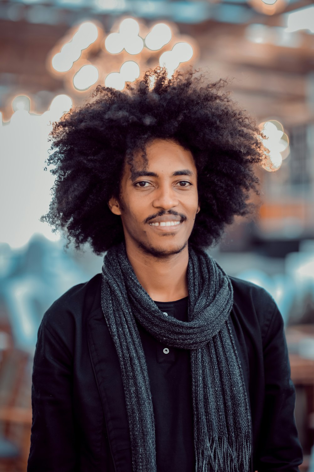 man wearing gray scarf and black long-sleeved shirt