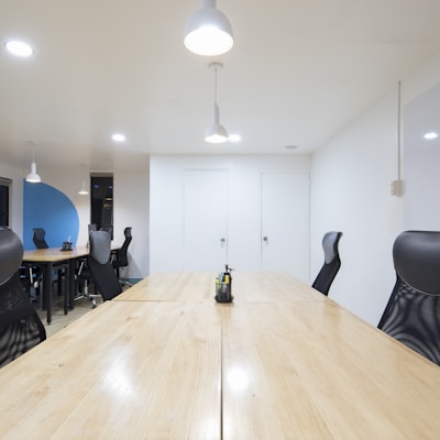 black rolling chairs and brown wooden table