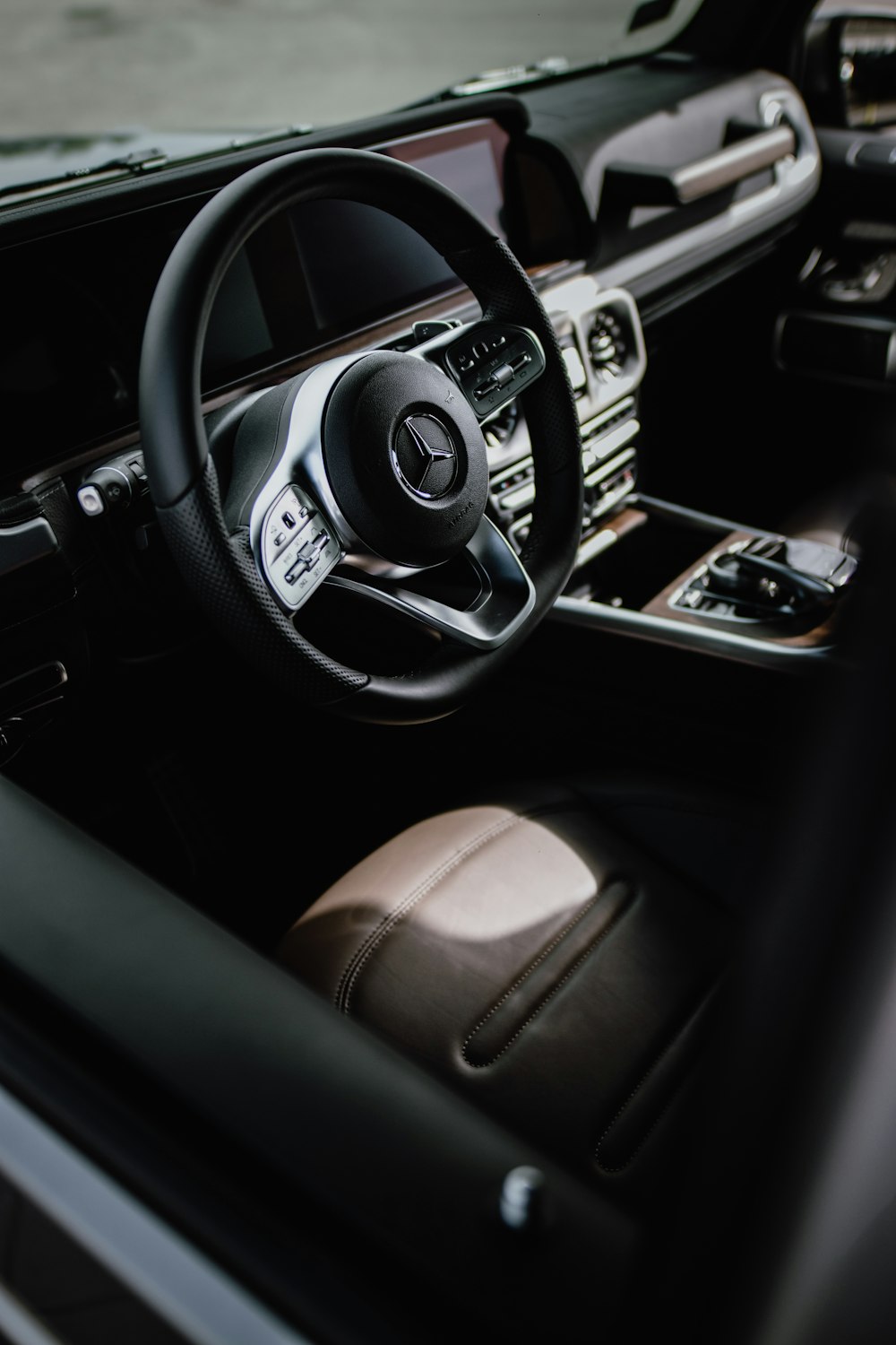 black Mercedes-Benz vehicle steering wheel
