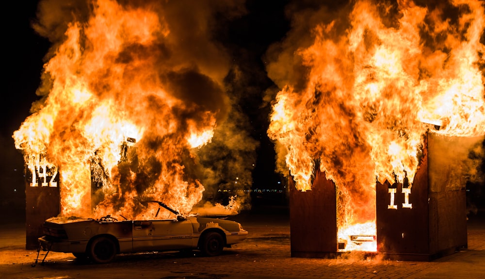 a car is parked in front of a huge fire