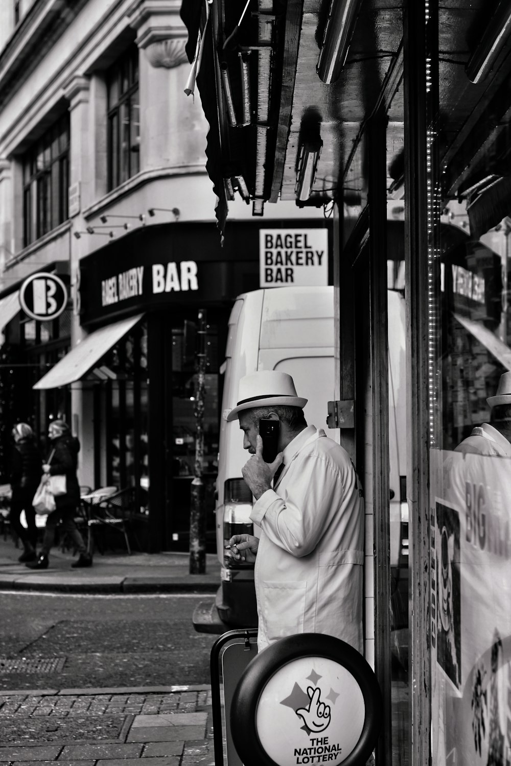 grayscale photography of man with phone on ear