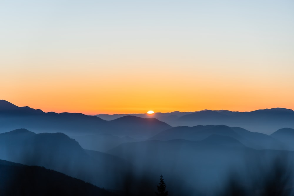 blue mountains under a clear sky during golden hour