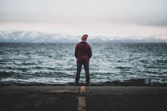 man standing in front of the sea in Tahoe Lake United States