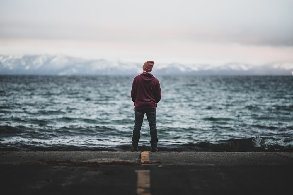 man standing in front of the sea