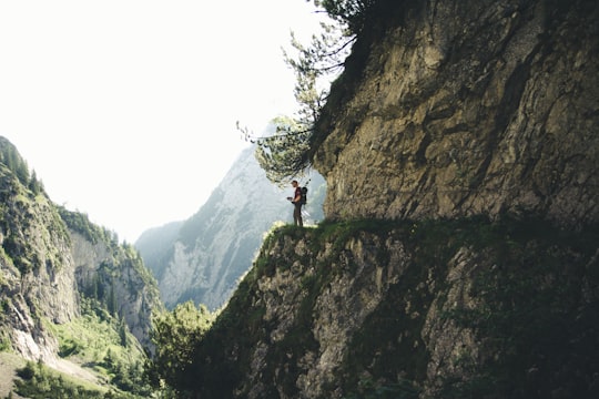 man stands at the cliff in Alpspitze Germany