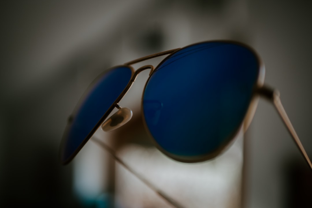 gold framed blue lens aviator-style sunglasses