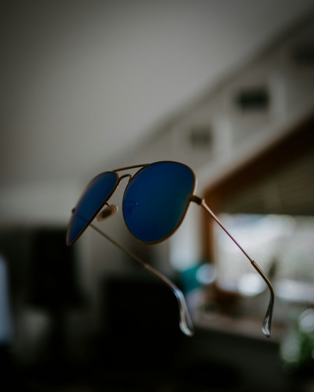 silver-colored framed blue sunglasses