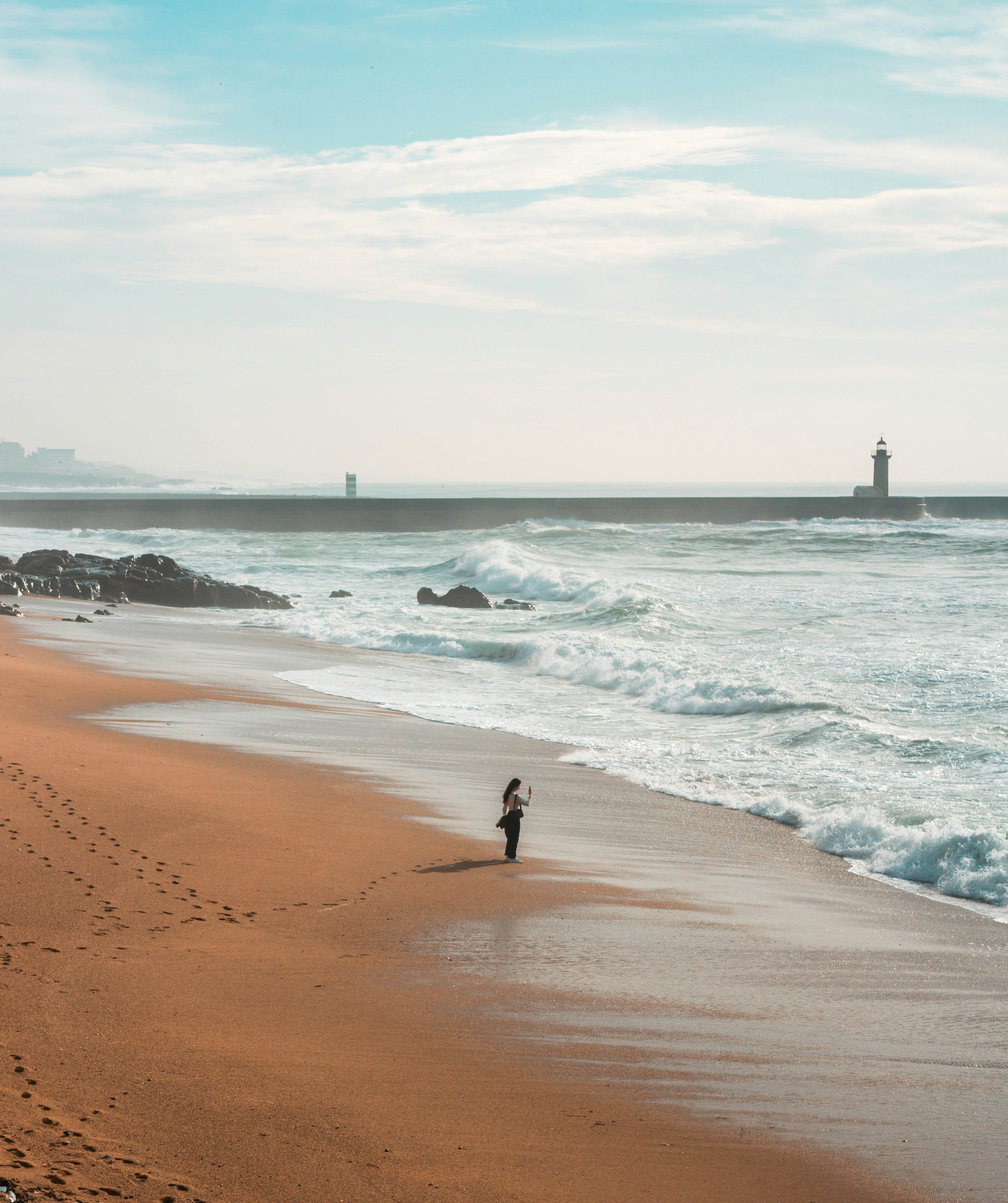 woman standing on shore during daytime