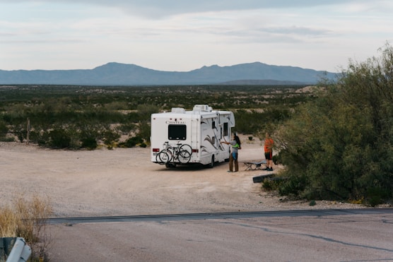 man standing beside truck