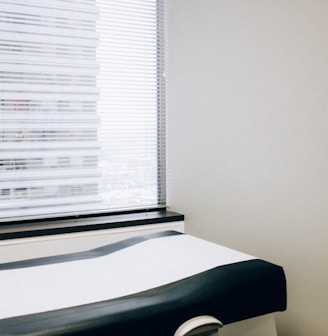 a hospital room with a bed and a window