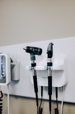 a couple of hair dryers sitting on top of a wall
