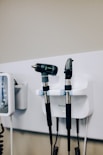 a couple of hair dryers sitting on top of a wall