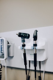 2 othoscopes sitting on top a wall