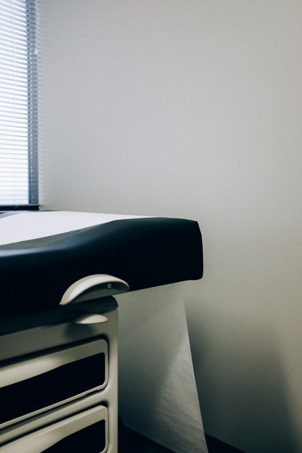 a black and white photo of a hospital bed