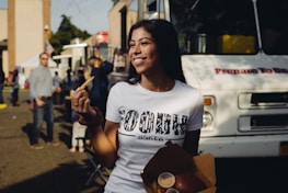 Happy customer smiling while collecting food from a vibrant NYC food truck.