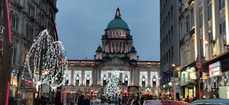 The historic Kress building warmly lit with holiday decorations and families enjoying the festivities.