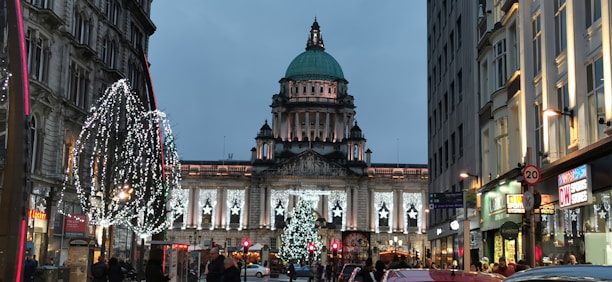 The historic Kress building warmly lit with holiday decorations and families enjoying the festivities.