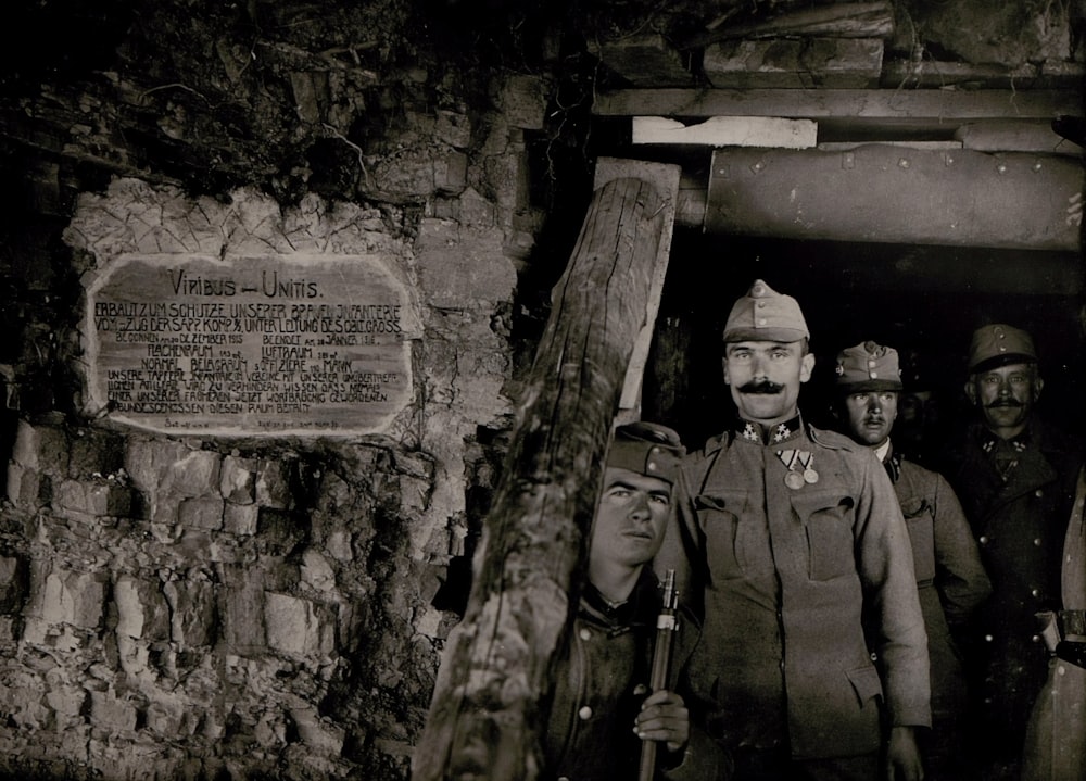 grayscale photography of people inside tunnel