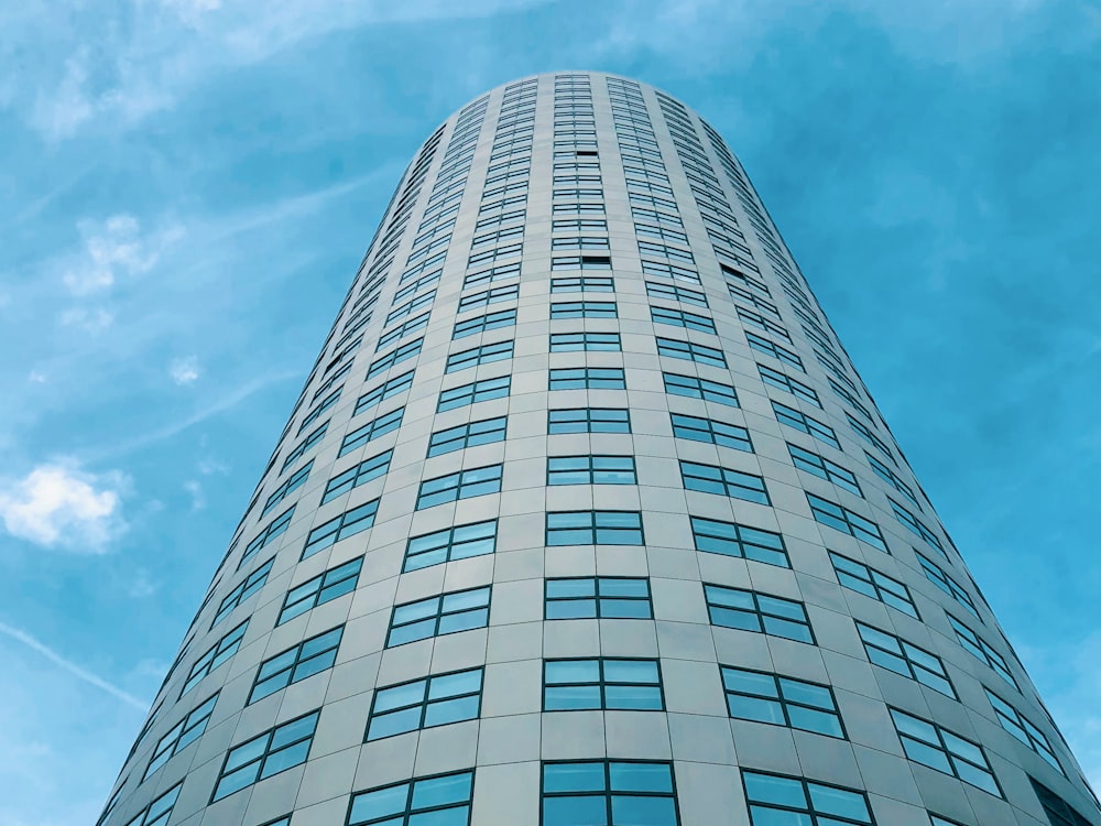 low-angle photography of a blue high-rise building