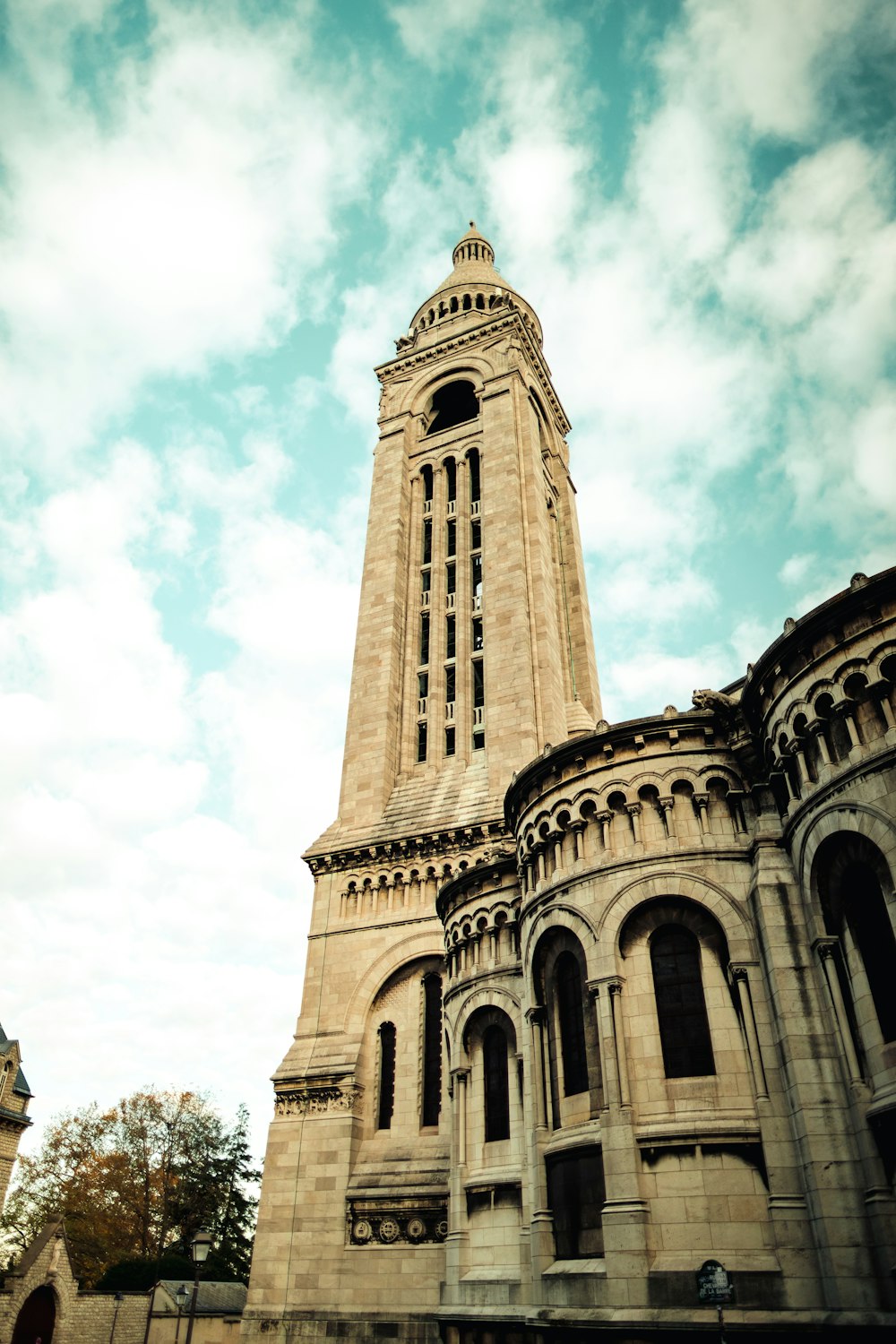 low-angle photography of a brown cathedral under a cloudy sky during daytime