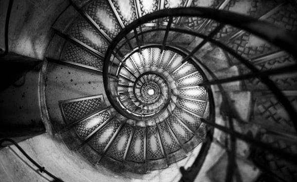 top view of spiral stairs in grayscale photo