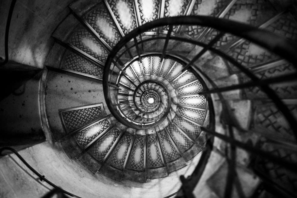 top view of spiral stairs in grayscale photo