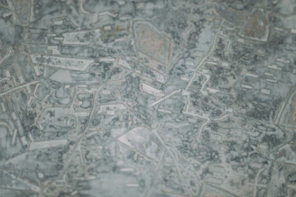 Abstract topographic map highlighting the border region, with dark navy and terracotta accents symbolizing connection and journey.