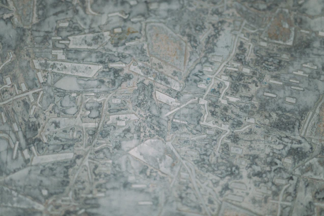 Abstract topographic map blending desert mountains and urban grids symbolizing the Mexico-USA connection.