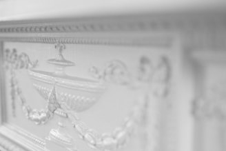 Close-up of a finely carved wooden decorative panel with intricate patterns