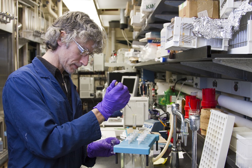 woman dropping a specimen on a test tube