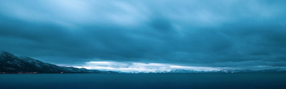 a large body of water under a cloudy sky