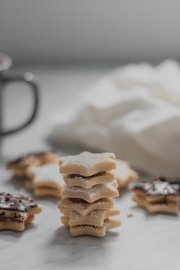 A close-up shot of Kayani Bakery's Shrewsberry cookies stacked neatly on a rustic wooden table.