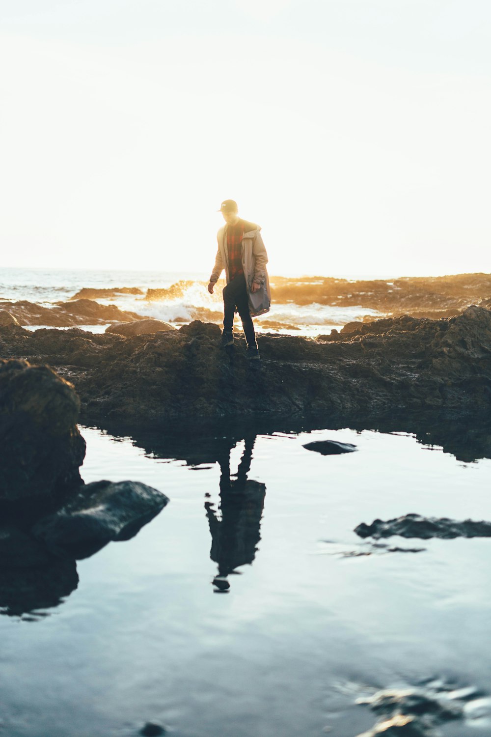 man standing near body of water