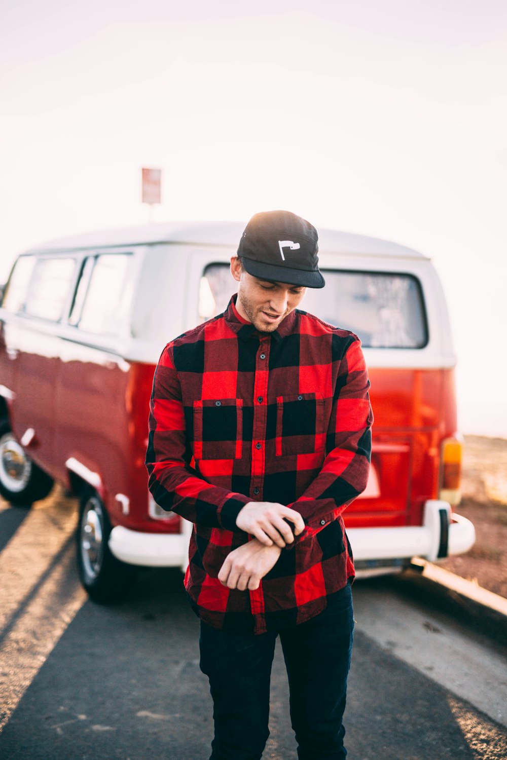 man in black and red dress shirt and black pants standing outdoors