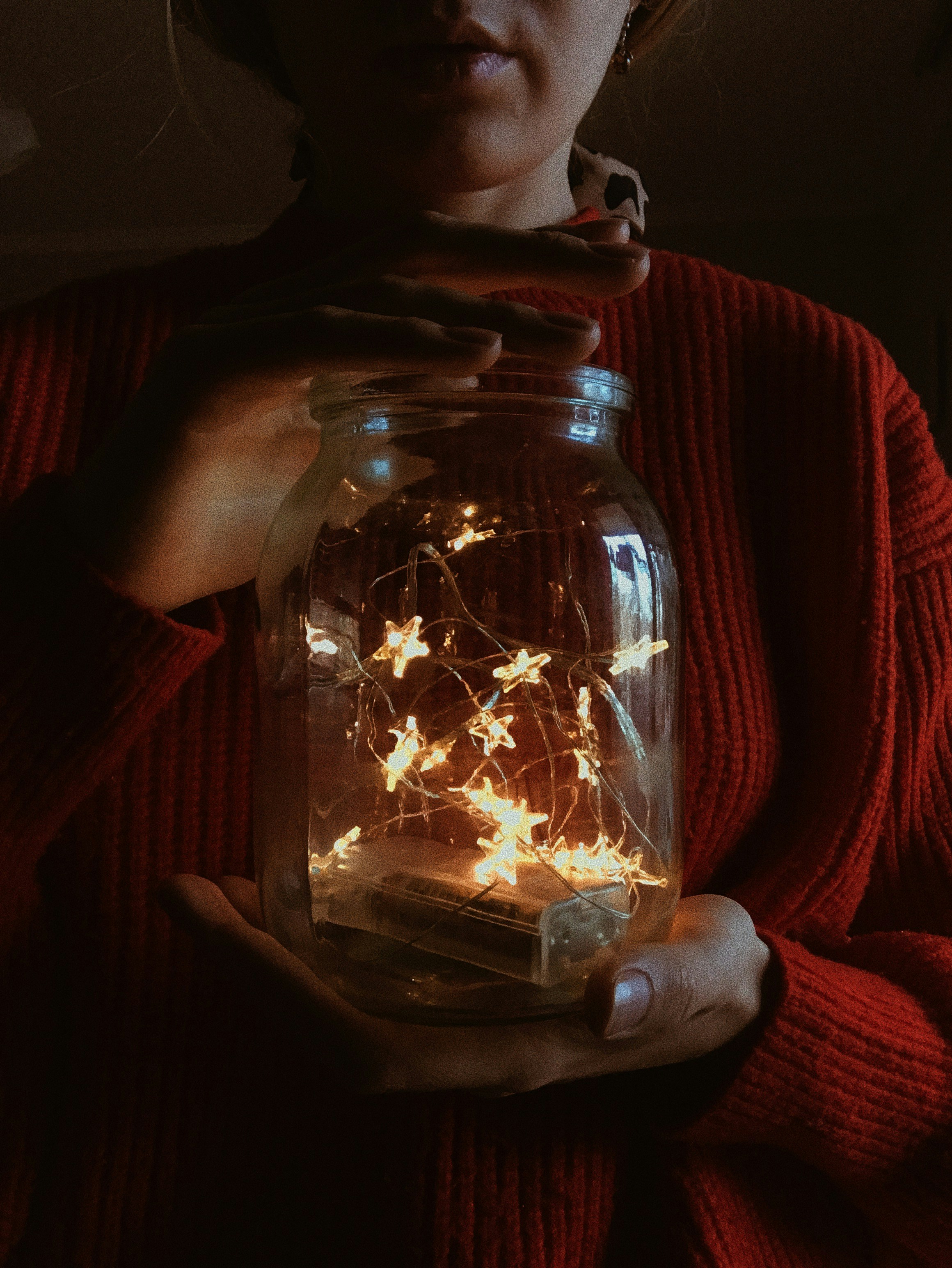 jar of turned on string lights