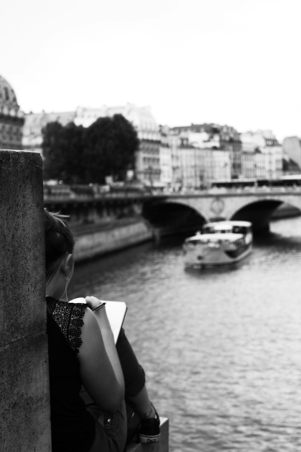 grayscale photography of woman writing on notebook