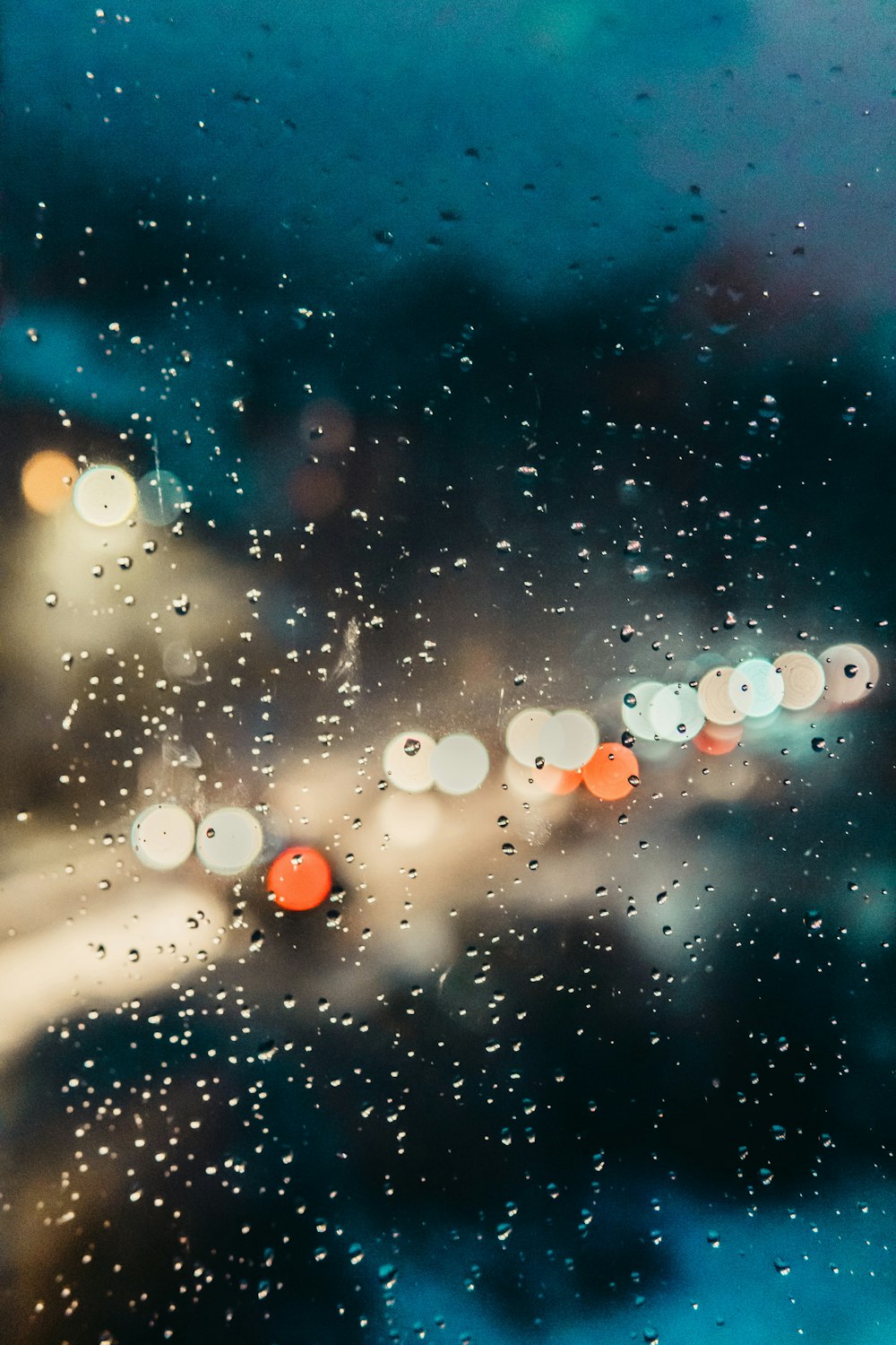 bokeh photography of water on glass