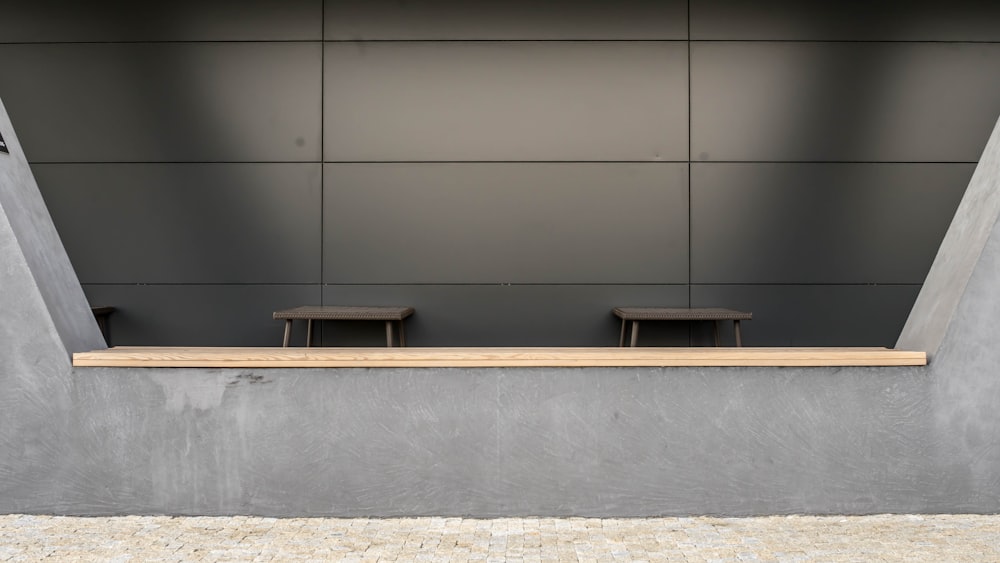 brown wooden table beside white wall