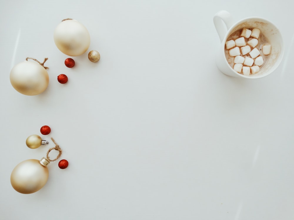 gray baubles beside white mug