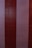 Vertical stripes in alternating shades of red and off-white are painted on a textured concrete surface, which displays signs of wear and subtle imperfections throughout.