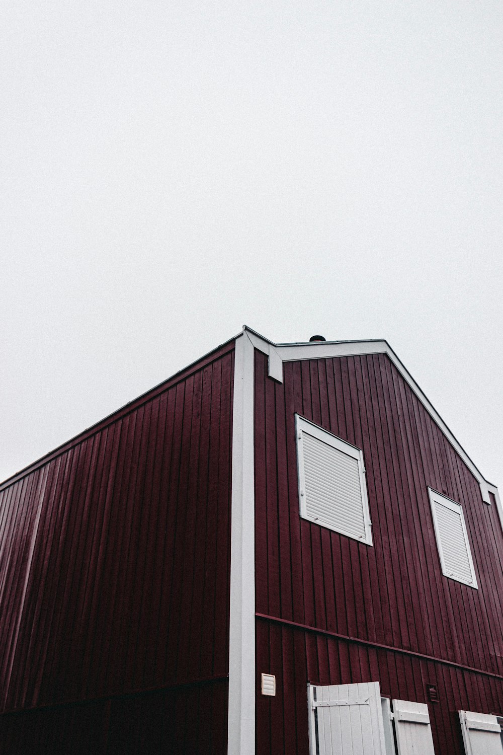 low-angle photography of red wooden house