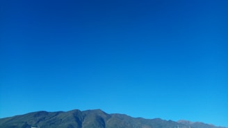 A peaceful landscape with mountains and a clear blue sky, symbolizing freedom.